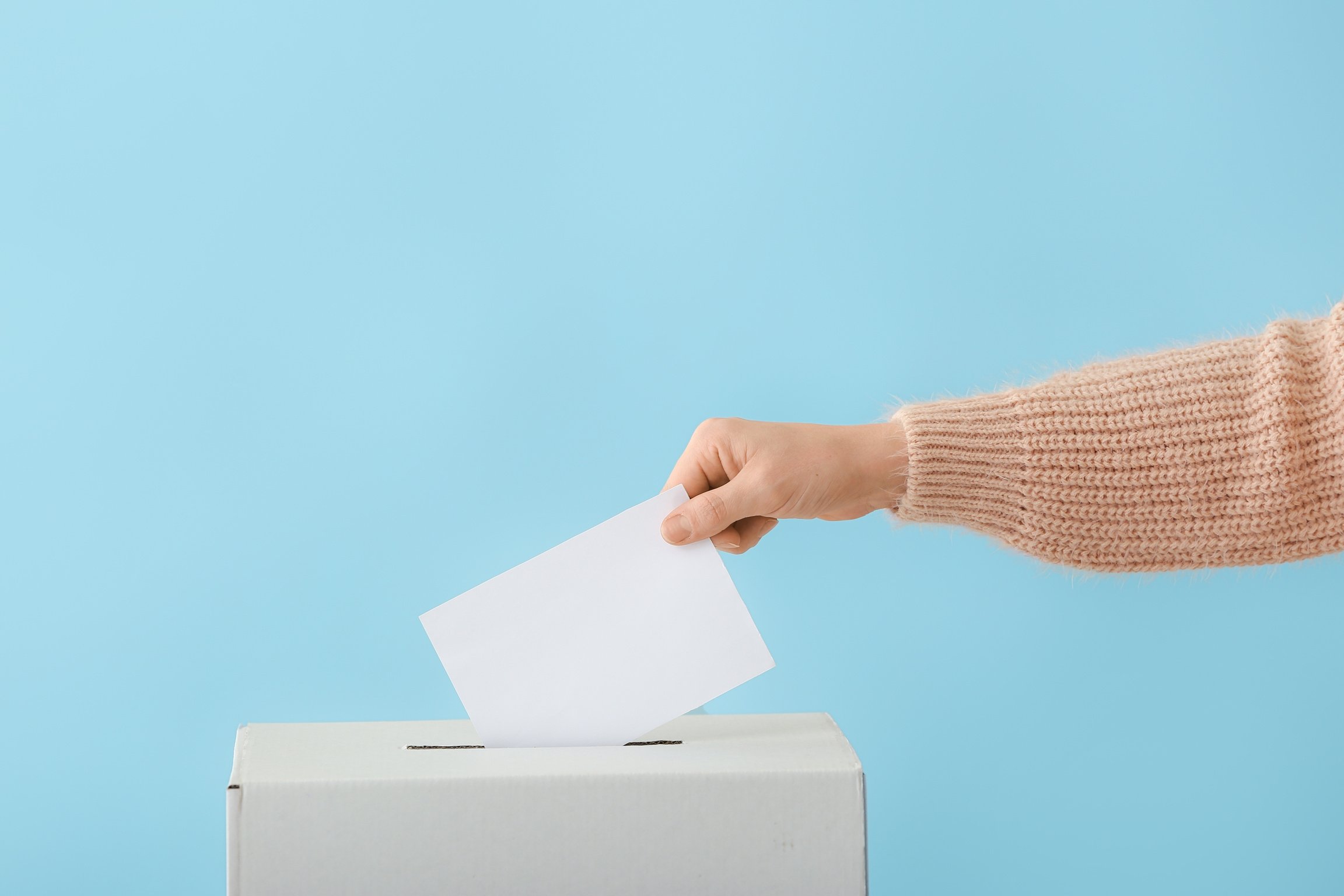 Voting in the Ballot Box on Color Background